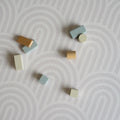 Colorful wooden blocks on a textured rainbow pattern play mat