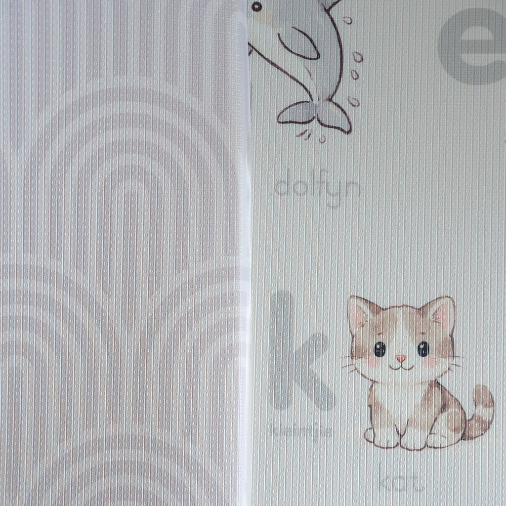 A reversible children's play mat with a alphabet design on the one side and a rainbow textured pattern on the other.
