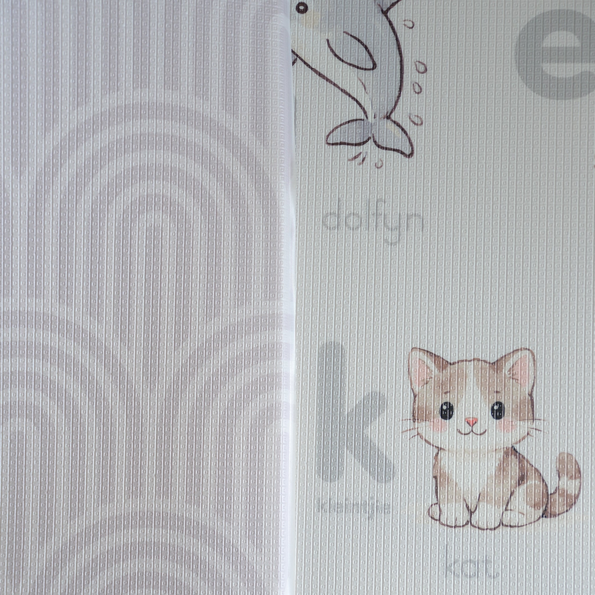 A reversible children's play mat with a alphabet design on the one side and a rainbow textured pattern on the other.