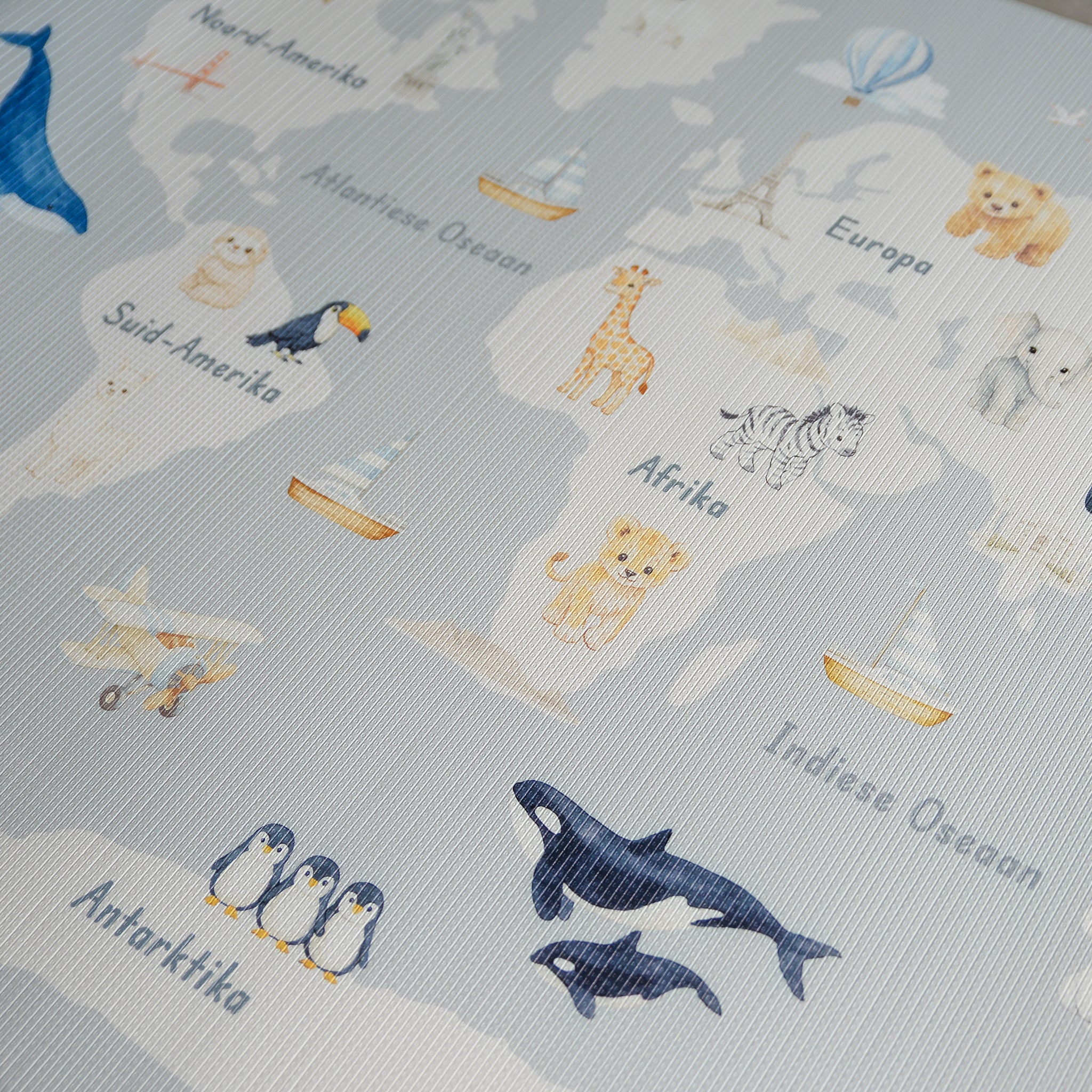 Children's play mat with animal illustrations on an Afrikaans world map