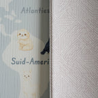 A reversible children's play mat with a world map design on the one side and a dots textured pattern on the other.