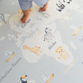 Play mat with animal illustrations on an Afrikaans world map and child's feet