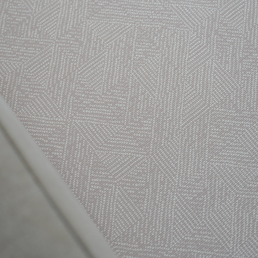 A foam play mat with a beige dots textured pattern