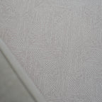 A foam play mat with a beige dots textured pattern