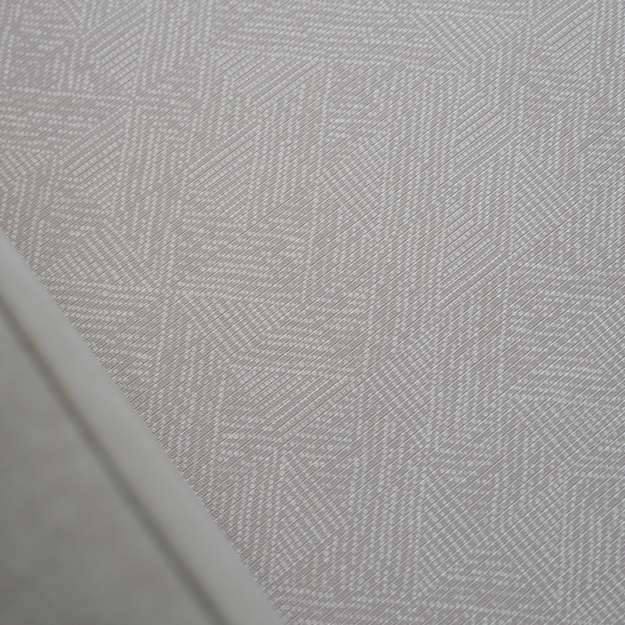 A foam play mat with a beige dots textured pattern