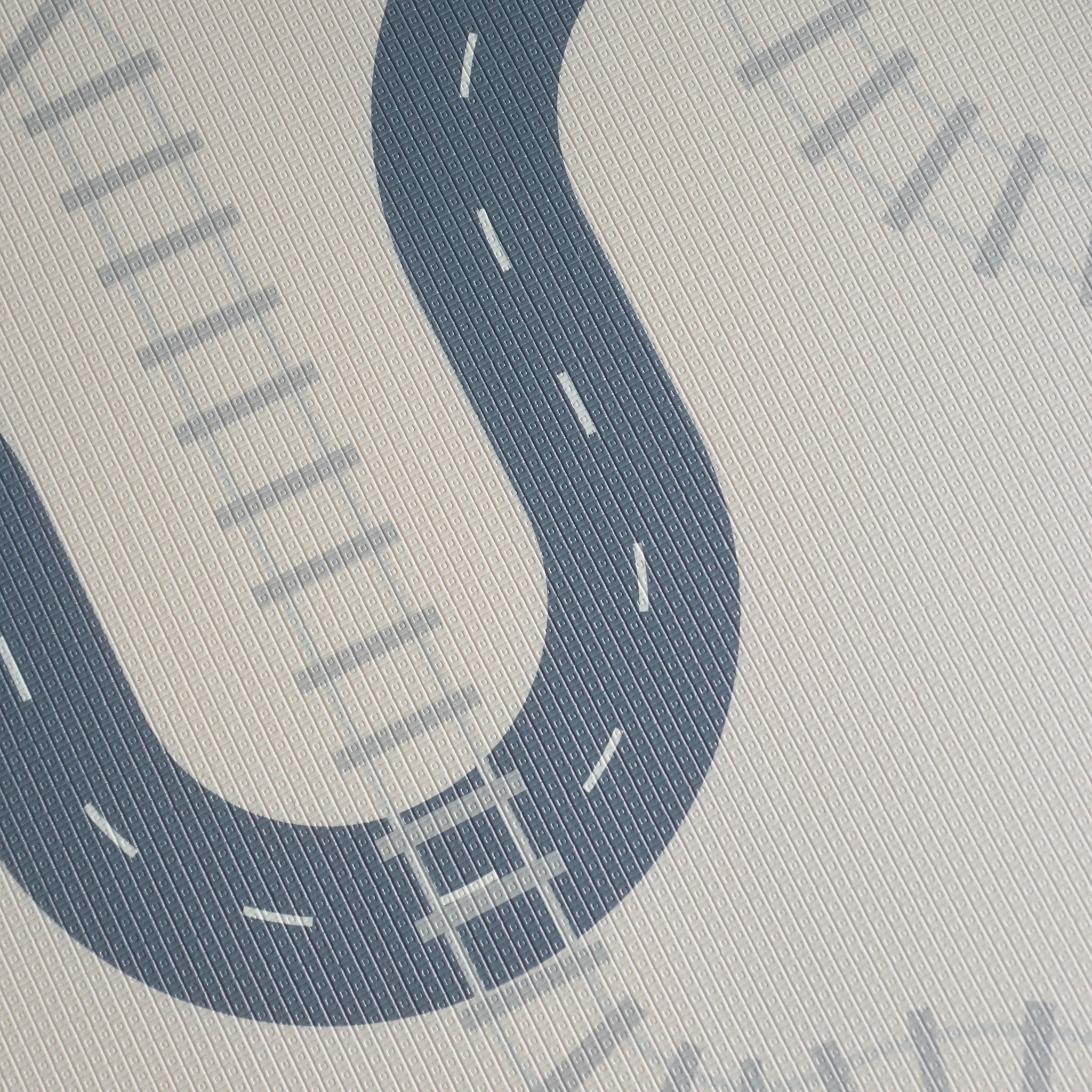 Play mat with road design on a light gray background