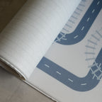 Reversible foam play mat with a herringbone pattern on the one side and a road design on the other.
