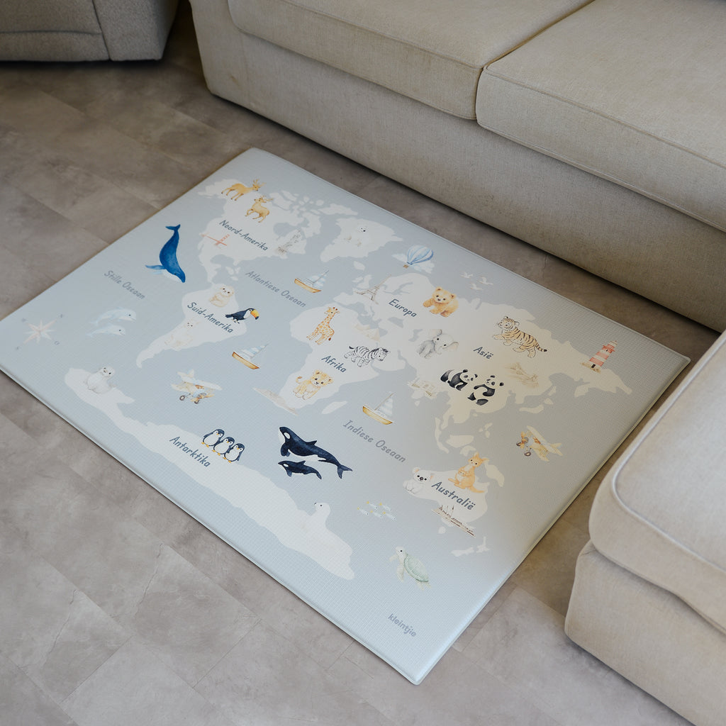 Children's World Map Play Mat on a beige vinyl floor.
