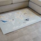 Children's World Map Play Mat on a beige vinyl floor.