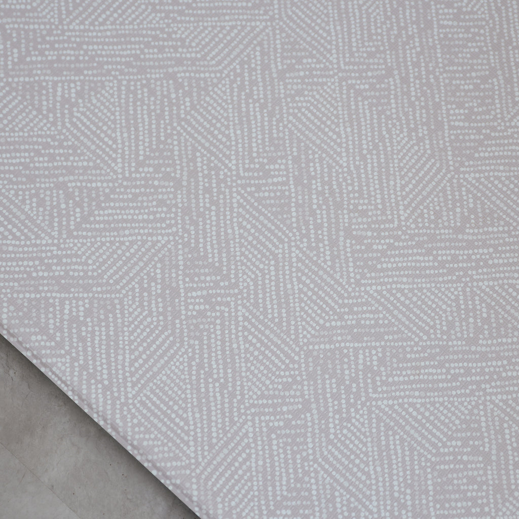 Dotted patterned play mat in a room