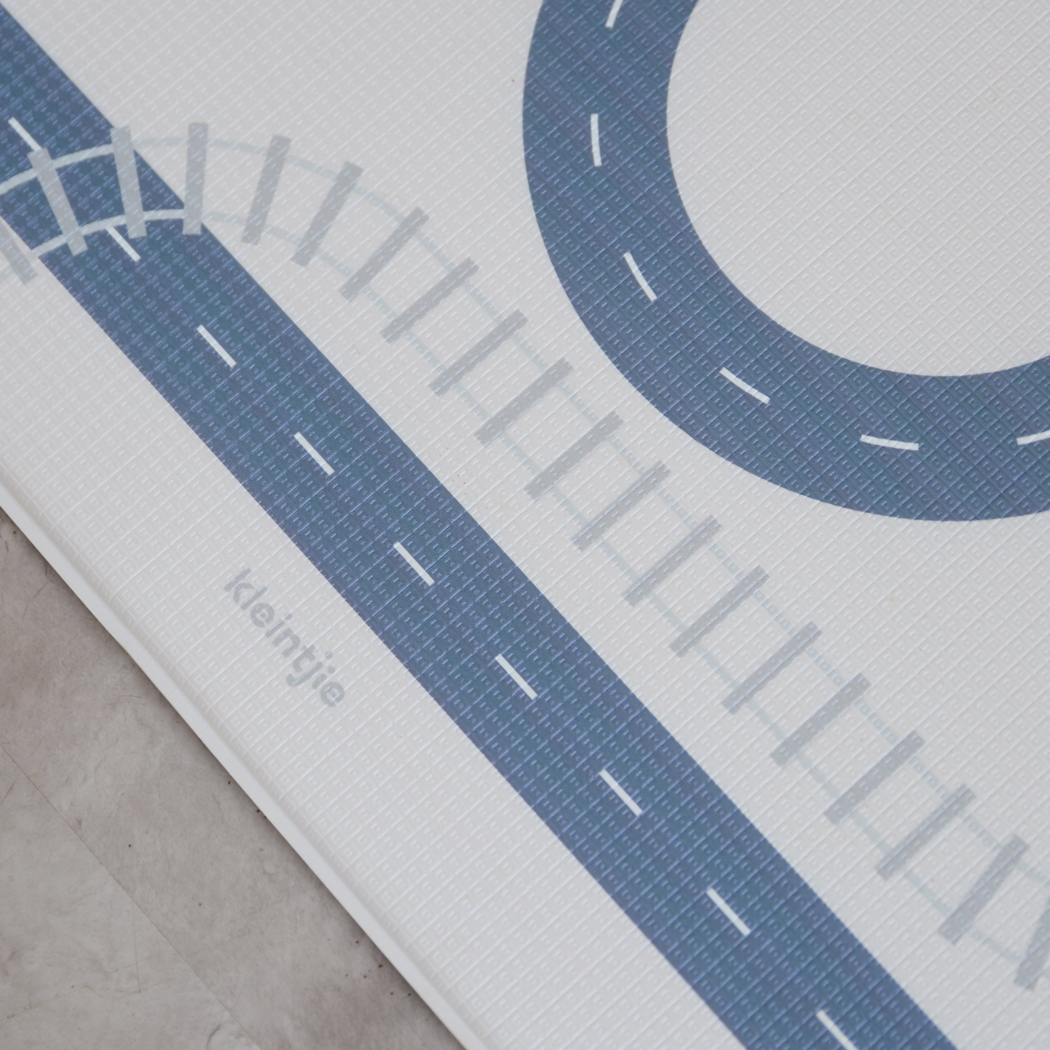 Detail shot of a car track play mat in a room
