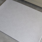 Beige dots textured play mat on a concrete floor