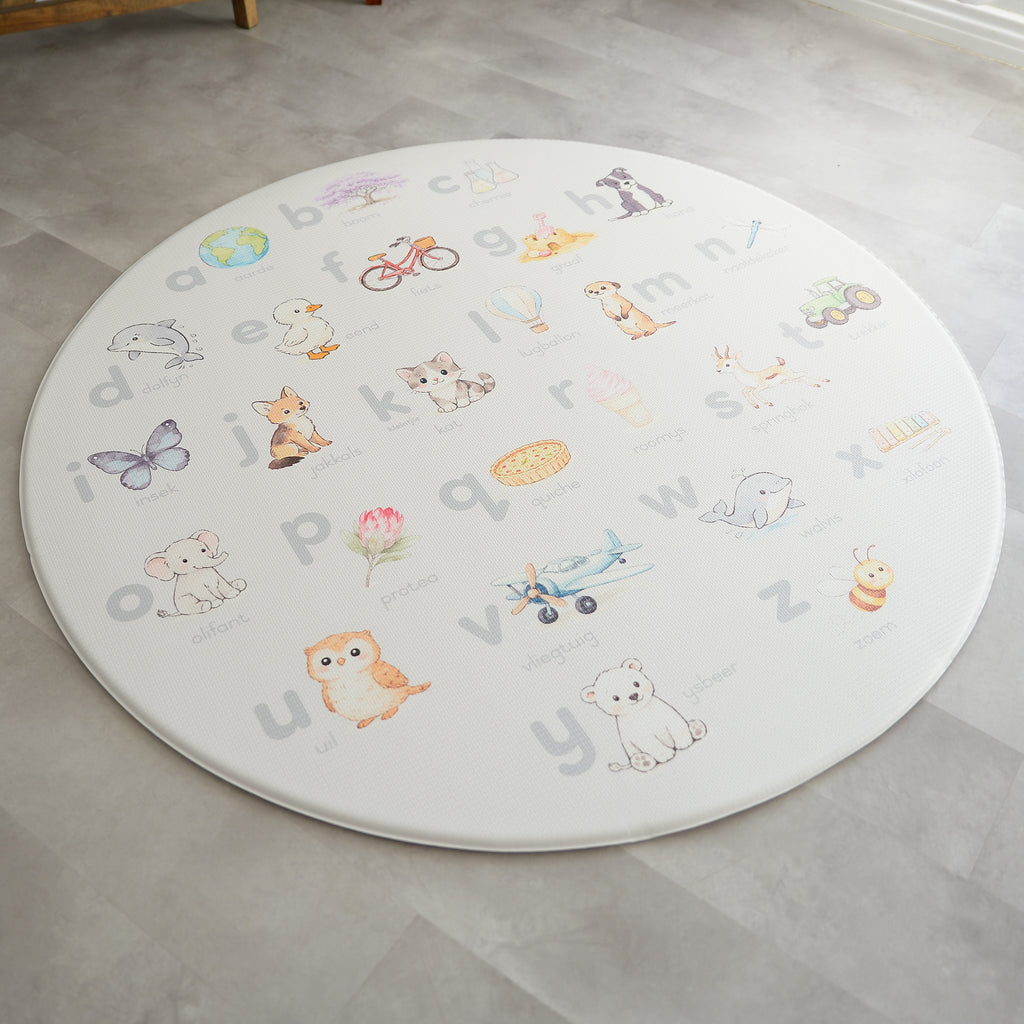 Afrikaans Alphabet play mat on a concrete floor.