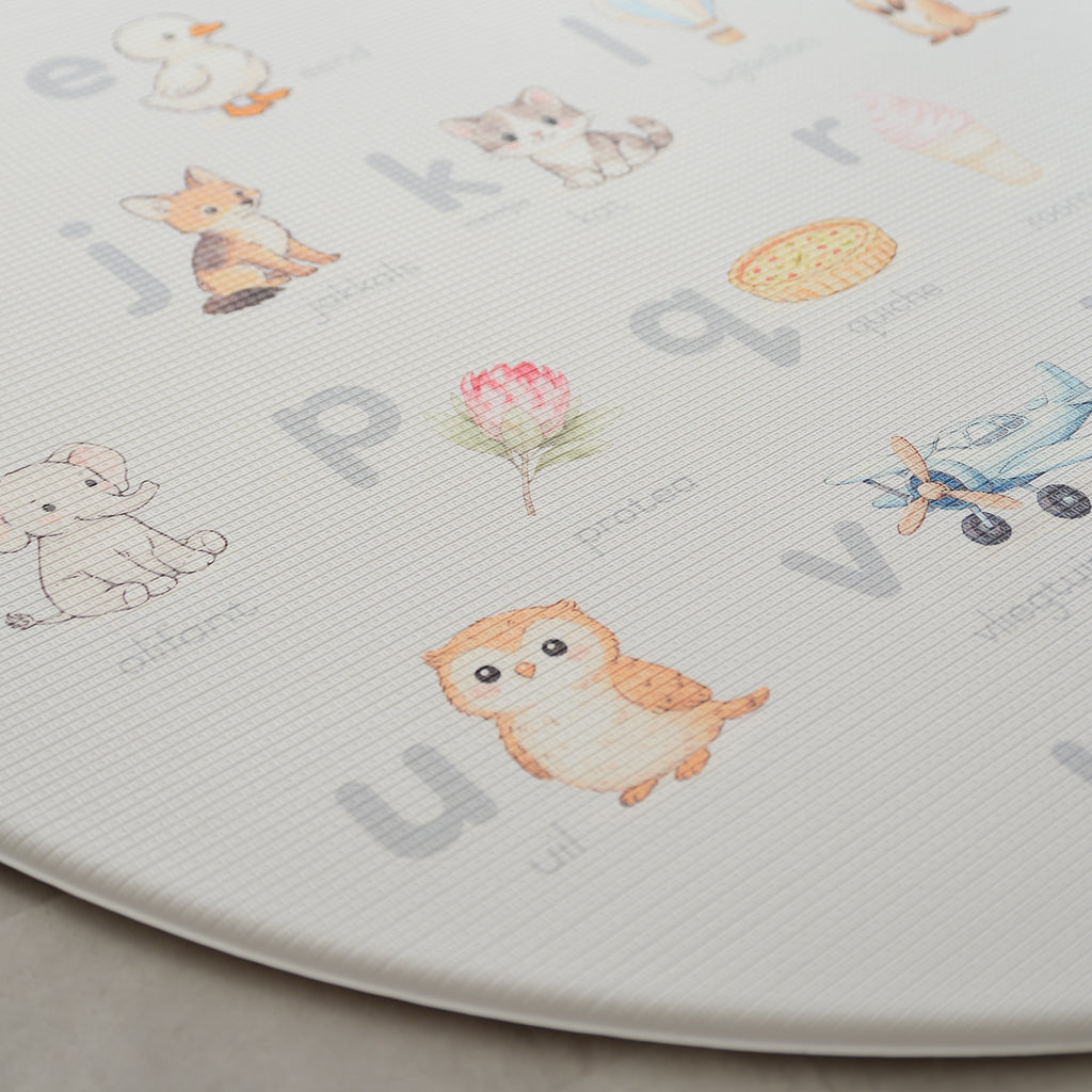 Afrikaans Alphabet play mat on a concrete floor.