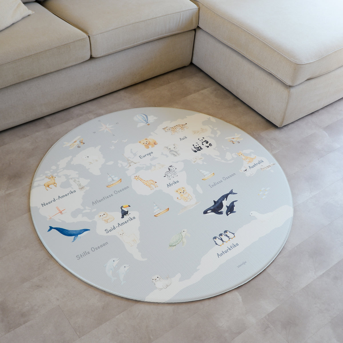 Afrikaans World Map play mat on a concrete floor.