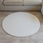 Sage play mat with a herringbone pattern on a concrete floor.