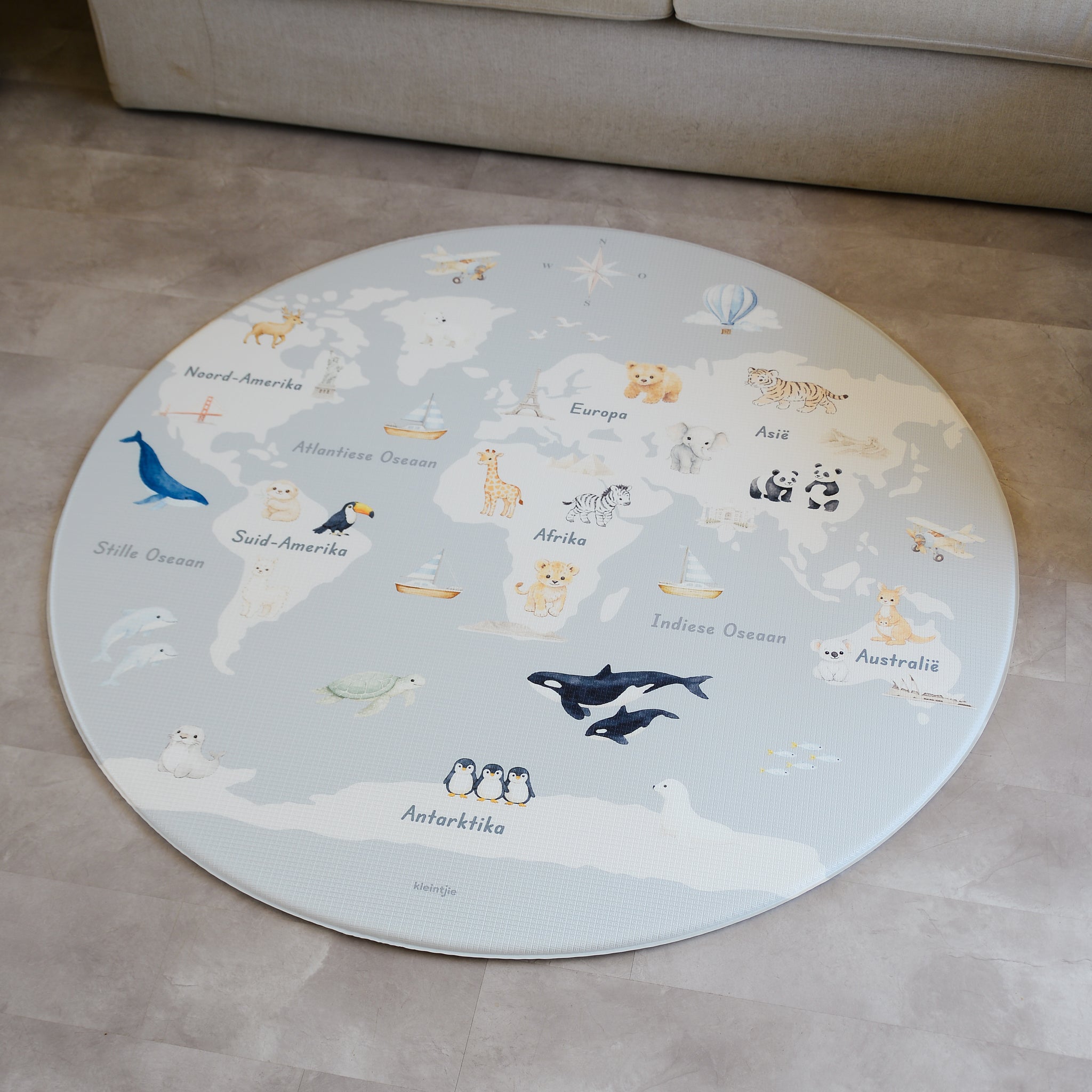 Afrikaans World Map play mat on a concrete floor.