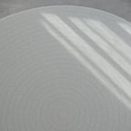 Sage play mat with a herringbone pattern on a concrete floor.