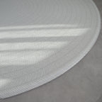 Sage play mat with a herringbone pattern on a concrete floor.